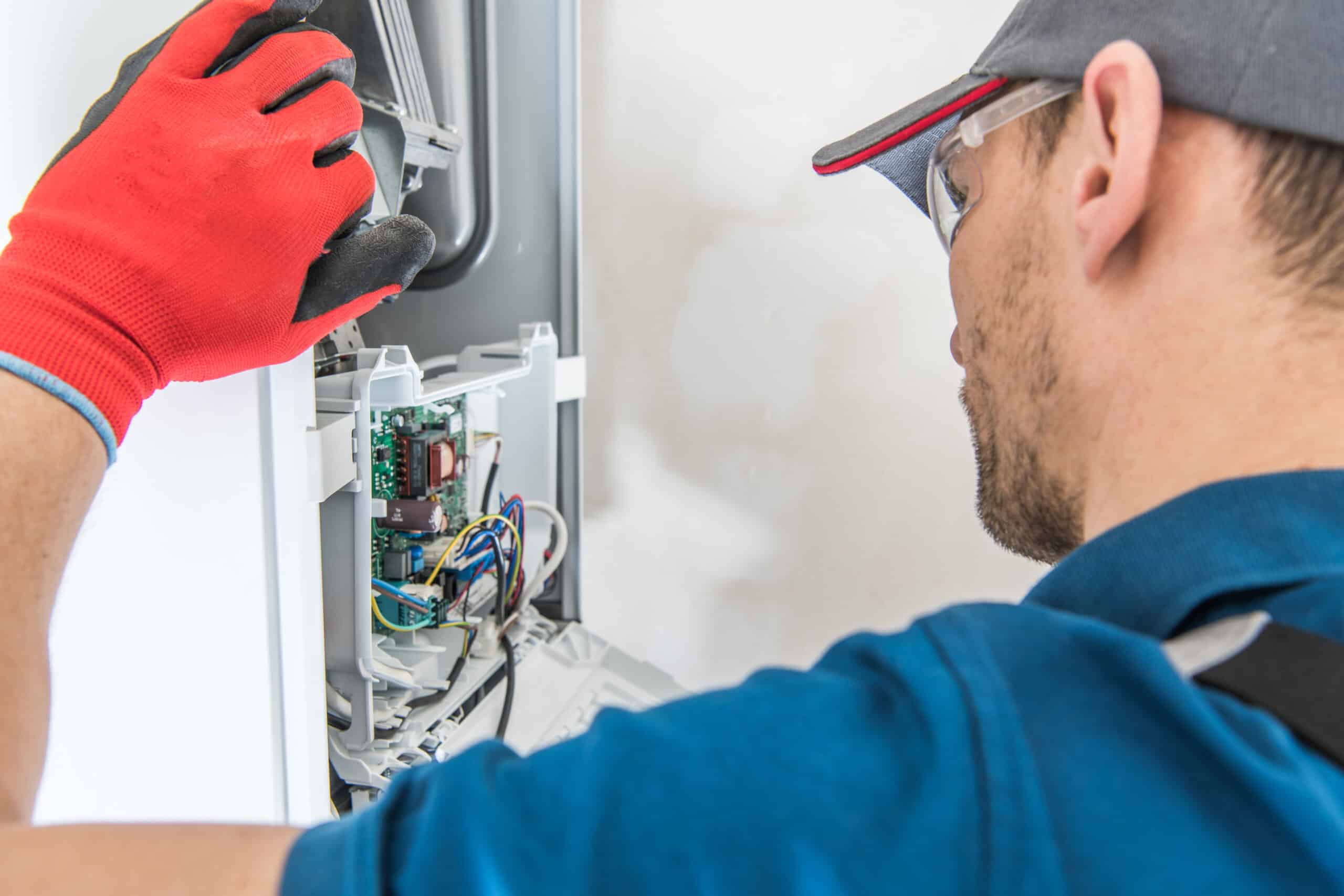 Technician performing a repair service on a gas furnace 