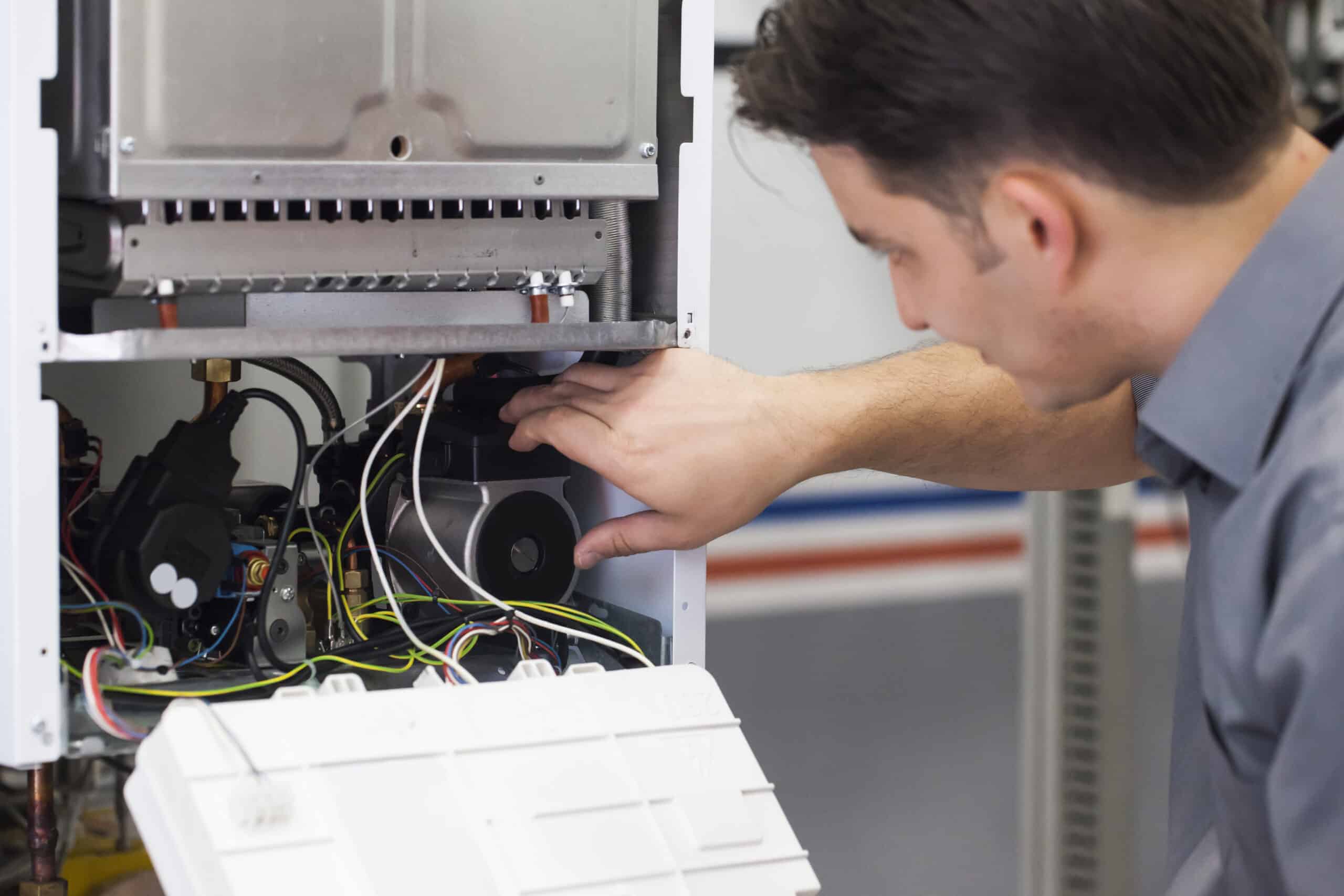 Technician performing a maintenance service on a residential heating system